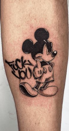 a mickey mouse tattoo on the leg