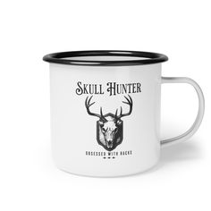 a white and black enamel mug with the words skull hunter on it