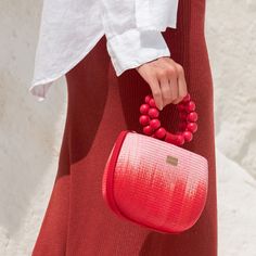 Introducing our red and pink Maria bag. This stunning bag offers a unique statement look with elevated luxury vacation moments in mind. You'll be sure to get admiring glances with this beautiful bag on your arm.  Crafted by artisans in the Philippines, this bag is created using woven Buntal straw - a natural and organic fiber from large leaves of abundant palm trees that are grown sustainably in the Philippines. Each piece of fiber is then meticulously handwoven to create a unique and natural te Luxury Summer Bags With Round Handle, Luxury Pink Beach Bag, Luxury Pink Beach Bags, Luxury Shoulder Bag With Round Handle For Summer, Red Shoulder Bag With Round Handle For Shopping, Elegant Red Bag For Vacation, Elegant Red Bags For Vacation, Chic Pink Bag With Bamboo Handle, Chic Red Bags With Round Handle