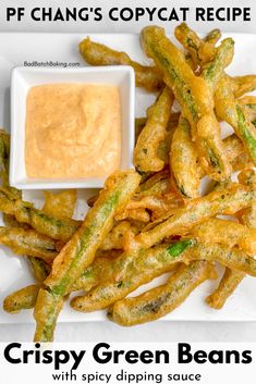 a white plate topped with french fries and dipping sauce