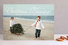 a christmas card with the words be joyful and two children pulling a sleigh