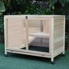 a wooden outdoor sauna with glass doors on the outside, and grass in front