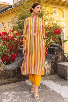 Mustard georgette kurta with multi-colored striped print and hand embroidered front placket and sleeves. Comes with trousers.
Components: 2
Pattern: Printed, Hand embroidered
Type Of Work: Striped
Neckline: Mandarin collar
Sleeve Type: Three quarter
Fabric: Georgette, Lining : Cotton
Color: Yellow, Multi Color
Other Details: 
Attached lining
Occasion: Mehendi and Haldi,Sangeet - Aza Fashions Suits Design Latest, Collar Kurta, Georgette Kurta, Salwar Suit Designs, Printed Kurti, Fashion App, Suit Designs, Floral Stripe, Mandarin Collar