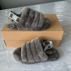 Brand New Ugg Fluff Yeah Slide Size 2 In Kids Color Charcoal Sheepskin Upper And Lining Elastic Back Strap Rubber Outsole They Have The Hologram As Shown In The Picture To Prove Authenticity. Grey Uggs, Purple Slippers, Ugg Dakota Slippers, Cute Uggs, New Uggs, Fluff Yeah Slide, Ugg Slides, Ugg Kids, Blue Slippers