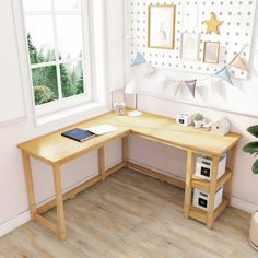 a corner desk with a phone on it next to a potted plant in front of a window