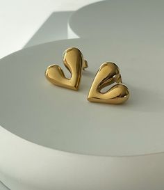 A mini take on our Amie Hammered Heart Earrings, this is the perfect way to add something special into your collection without going too big. The Mila comes with two backing options to wear with comfort everyday. 18K gold plating on stainless steel Water resistant, hypoallergenic Gold-plated Heart Earrings For Everyday Wear, Elegant Stainless Steel Heart Earrings, Everyday Heart-shaped Gold Plated Earrings, Gold Heart Earrings Modern Style, Modern Gold Heart Earrings For Pierced Ears, Casual Gold Heart Earrings, Modern Gold Heart Earrings For Anniversary, Gold Heart Earrings For Everyday, Everyday Gold Heart Earrings