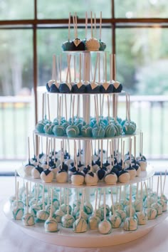 a tiered cake with blue and white candies on it