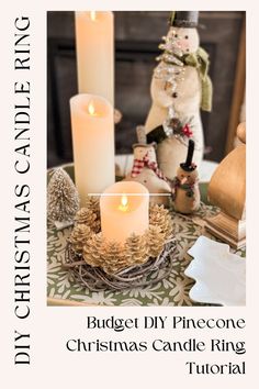 a candle is sitting on top of a table with other christmas decorations and candles in front of it