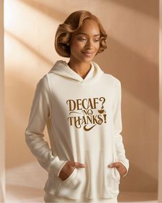 a woman wearing a white hoodie that says decaf? no thanks