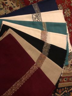 several different colored rugs laying on top of each other