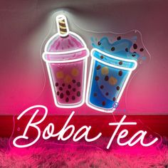 a neon sign that says boba tea and a drink