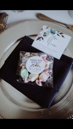 a place setting with napkins and flowers on it