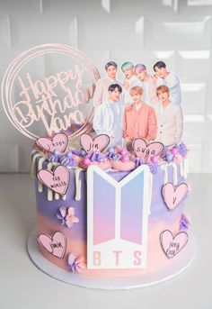 a birthday cake decorated with the bts and happy birthday photo on top, surrounded by hearts