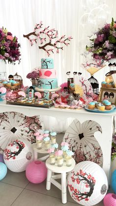 a table topped with lots of cakes and cupcakes