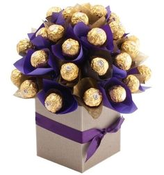 a bouquet of chocolates wrapped in purple ribbon