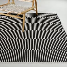 a chair sitting on top of a black and white rug