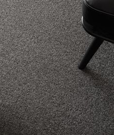 a black chair sitting on top of a carpeted floor