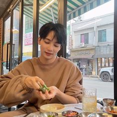 a man sitting at a table with food in front of him