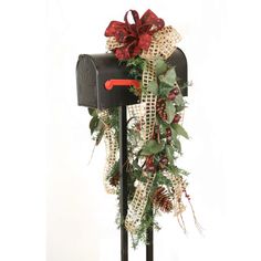 a mailbox decorated with pine cones and burlucks for the holiday season