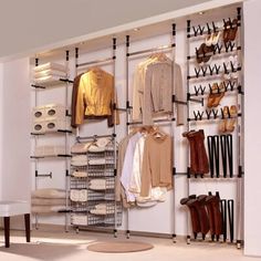 an organized closet with shoes, jackets and boots on shelves in the corner next to a chair