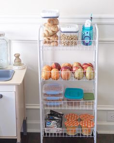 a white metal shelf filled with lots of food