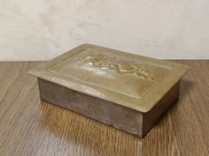 a metal box sitting on top of a wooden table