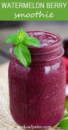 a jar filled with blueberry smoothie on top of a table