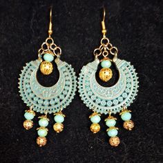 Aztec inspired gold and turquoise colored medallions feature turquoise and gold filligree beads dropping from them. Aztec Accessories, Southwestern Green Dangle Earrings, Beaded Aztec Earrings, Aztec Jewelry, Aztec Earrings, Bohemian Turquoise Hand-tooled Earrings, Turquoise Color, Labour Day, Jewelry Earrings Dangle