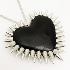 The Double Row Spiked Heart is a Bunny Paige classic. Dozens of spikes are individually hand-applied to give each heart its iconic double row halo. Spiked Heart Pendant: 2.5" wide 16" silver plated or gunmetal chain + 2" extender 100% handmade All jewelry comes beautifully gift wrapped Black Heart-shaped Jewelry For Alternative Fashion, Black Heart Jewelry For Alternative Fashion, Edgy Handmade Necklaces For Party, Unique Black Jewelry For Alternative Fashion, Black Gothic Jewelry With Spikes, Edgy Handmade Necklaces For Alternative Fashion, Handmade Edgy Necklaces For Alternative Fashion, Edgy Spiked Jewelry For Parties, Trendy Black Necklaces For Alternative Fashion