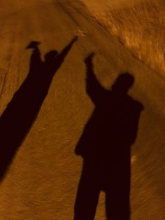 the shadow of two people on a skateboard