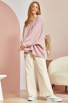 This blouse is out to prove that comfy and chic can coexist in perfect harmony. Its flowy, dolman cut gives you room to breathe while still maintaining a flattering drape. 3/4 sleeves keep it seasonal, transitioning effortlessly from summer to fall. A plunging V-neckline shows just enough skin to be subtly seductive, but the blush pink hue is as sweet and charming as an English rose garden. In short, this top lets you make a stylish statement without having to sacrifice one ounce of comfort. It’ Chic Tunic For Spring Loungewear, Relaxed Fit Long Sleeve Rayon Blouse, Feminine Rayon Tops For Fall, Chic Rayon Blouse For Loungewear, Oversized Blouse With Blouson Sleeves For Fall, Fall Feminine Rayon Tops, Effortless Rayon Blouse For Spring, Spring Rayon Long Sleeve Blouse, Flowy Blouse For Spring Loungewear