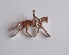 This is a sterling silver dressage horse pin / brooch.  It is in nice condition, no scratches etc. It is marked 925 for sterling silver. This pin has just been sitting in a jewelry box and has never been used.  The locking pin works fine. It measures 1 3/8" long x 1" tall. Nice gift for the dressage rider, eventer or horse lover. Weighs 4.9gm. Very Nice  PLEASE NOTE: I do not clean vintage silver as I like the patina of old silver, you may too. Classic Formal Jewelry With Horse Design, Formal Silver Jewelry With Horse Design, Horse Event, Show Horse, Equestrian Jewelry, Horse Pony, Pony Club, Dressage Horses, Horse Lover