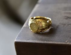 a gold ring sitting on top of a wooden table