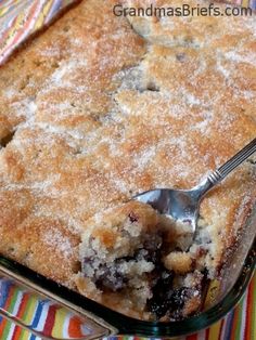 a close up of a pie in a pan with a spoon