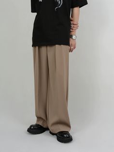 Experience tailored sophistication with our Wide Leg Tailored Pleated Trousers, a timeless addition to any wardrobe. Constructed with attention to detail, these trousers feature a high-waisted design and pleat detailing, offering a flattering silhouette. Crafted from a blend of soft fabrics, they provide both comfort and durability. The solid color pattern and meticulous tailoring ensure they stand out with a clean, professional look. Versatile and modern, these trousers can be styled with a tuc Modern Pleated Pants For Business Casual, Modern Pleated Pants For Workwear, Modern Wide-leg Pants For Semi-formal Occasions, Modern Semi-formal Wide-leg Pants, Modern Pleated Bottoms For Work, Solid Pleated High-waisted Dress Pants, Solid Color Pleated High-waisted Dress Pants, Modern Pleated Bottoms For Office, Modern Formal Pleated Pants