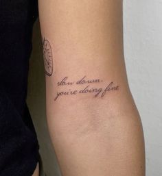 a woman with a tattoo on her arm that says, you are doing fine