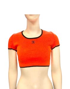 - Chanel orange cotton "CC" cropped top from spring 1995 collection. - Black piping trim. - Size 44. Spring Orange Cropped Crop Top, Orange Stretch Crop Top, Stretch Orange Cropped Top, Orange Stretch Crop Top With Short Sleeves, Orange Fitted Crop Top For Spring, Fitted Orange Crop Top For Spring, Fitted Cropped Orange Top, Fitted Orange Cropped Top, Chanel Orange