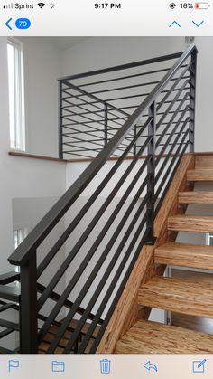 an image of a stair railing with wood handrails and metal balconies