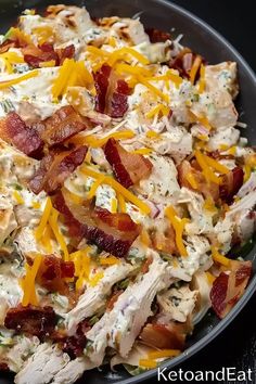 a pan filled with chicken, bacon and cheese