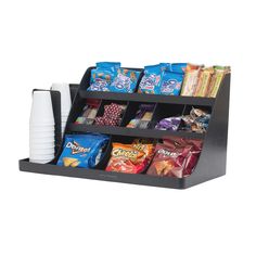 a black shelf with snacks and coffee cups on the bottom, in front of a white background