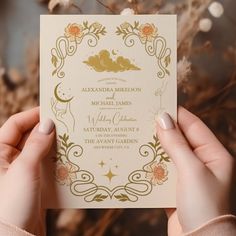 two hands holding up a wedding card