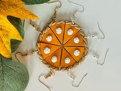 a piece of food is sitting on a table next to some leafy green and yellow leaves