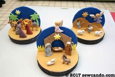 three small nativity figurines sitting on top of a table