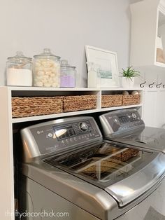 a washer and dryer sitting next to each other in a room with white walls