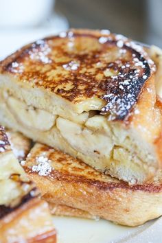 two pieces of french toast stacked on top of each other with powdered sugar on them