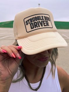 Hop aboard the Struggle Bus and rock this tan trucker hat! Perfect for anyone who knows the struggle of being a regular human, with an adjustable snap back for the perfect fit. Don't miss your chance to join the fun and funky Struggle Bus crew. One Size Fits Most Trucker Style Adjustable Snapback Tan Color Struggle Bus Driver Graphic Color May Vary From Different Viewing Device *This item is a final sale item! No returns or exchanges will be allowed on this item* Funny Adjustable Trucker Hat For Streetwear, Funny Adjustable Trucker Baseball Cap, Funny Adjustable Trucker Hat, Novelty Adjustable Trucker Hat For Streetwear, Struggle Bus, Cap Girl, Maxi Romper, Bus Driver, Shoe Boot Sandals