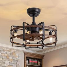 a light fixture in the middle of a room with stone walls and wood accents on the ceiling