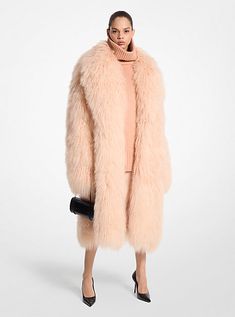 A dramatic take on outerwear, this coat reinvents the classic balmacaan style with a calf-grazing, oversized fit and dropped shoulders. Lined for easy layering, this showstopping piece is carefully crafted from Mongolian shearling distinguished by its plush, shaggy construction. Partner it with tonal separates for evening. Luxury Shearling Fur Coat For Winter, Fitted Elegant Shearling Fur Coat, Chic Shearling Fur Coat, Shearling Outerwear With Faux Fur Lining, Long Coat, Elegant Mink Shearling Fur Coat, Sheepskin Coat, Fashion Design Collection, Michael Kors Collection, Shearling Coat