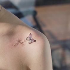 a woman with a butterfly tattoo on her shoulder