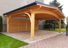 a large wooden carporture sitting on top of a brick walkway